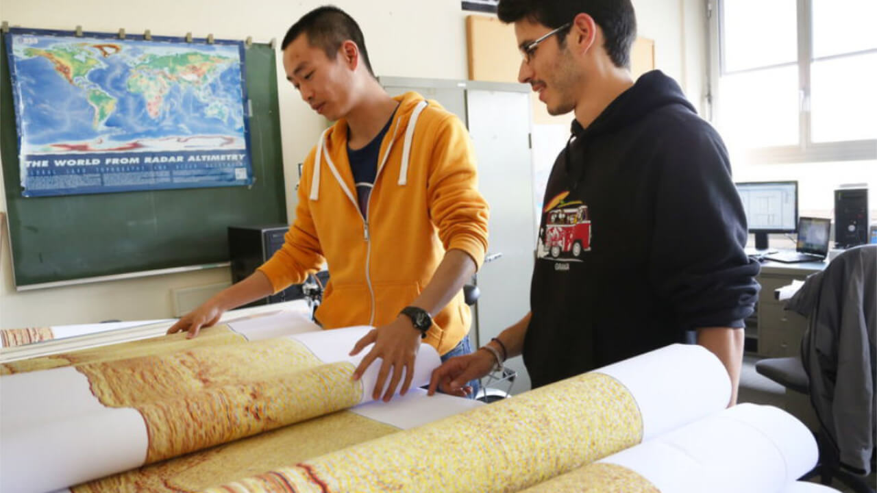 Two PhD students at work